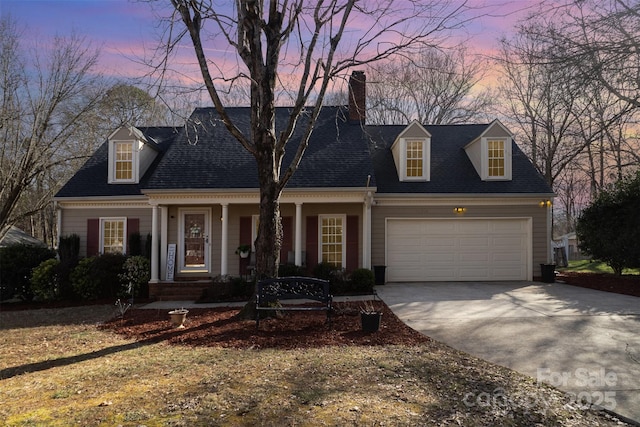 cape cod home featuring a garage