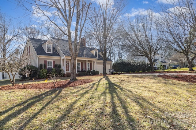 view of front of house featuring a garage and a front lawn