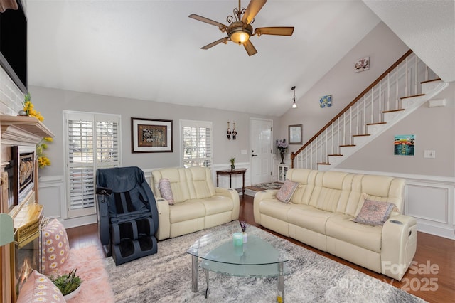 living room featuring vaulted ceiling, dark hardwood / wood-style floors, and ceiling fan