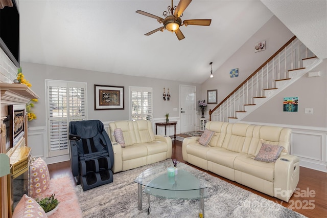 living room featuring ceiling fan, dark hardwood / wood-style floors, and vaulted ceiling