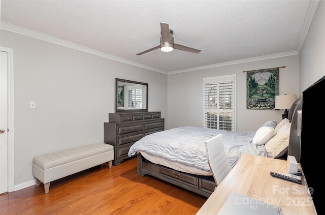 bedroom with hardwood / wood-style flooring, ornamental molding, ceiling fan, and a textured ceiling