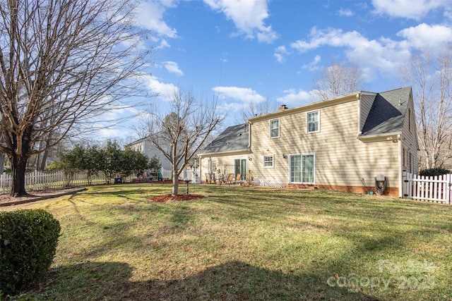 back of house with a yard