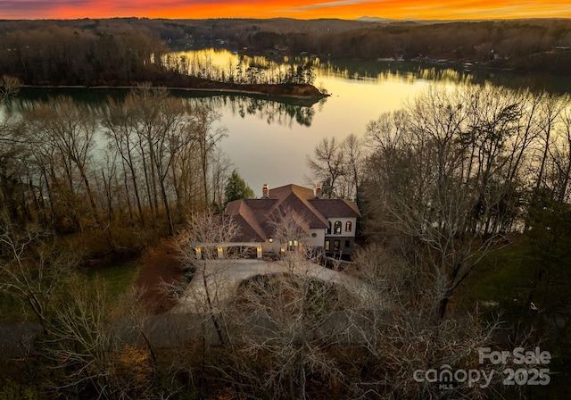 aerial view at dusk with a water view