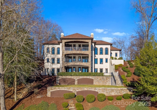 back of property with a balcony