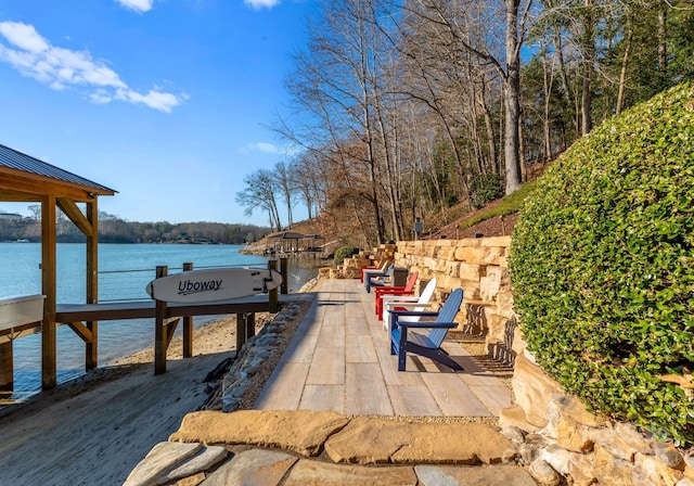 exterior space with a water view and a patio area