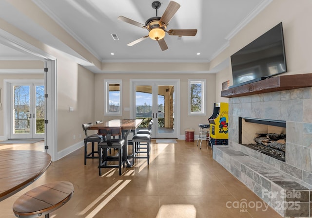 dining space with ornamental molding, french doors, and a healthy amount of sunlight