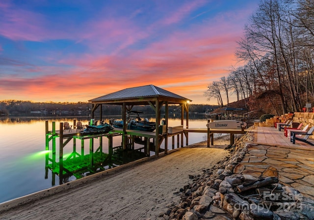 dock area with boat lift and a water view