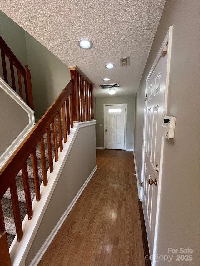 doorway featuring dark hardwood / wood-style floors and a textured ceiling