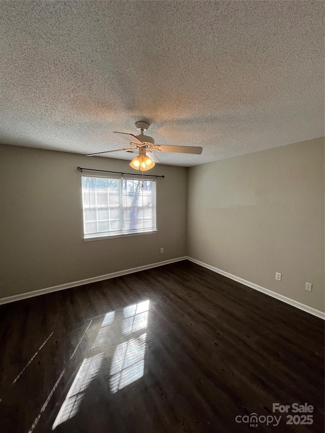 empty room with dark wood-type flooring, a textured ceiling, and ceiling fan