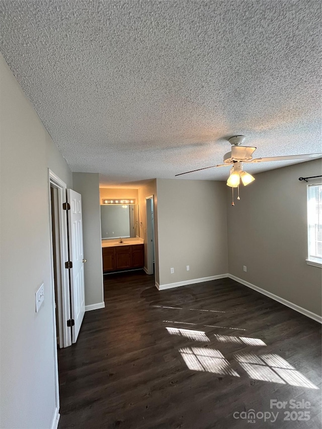 unfurnished room with dark wood-type flooring, ceiling fan, and a textured ceiling