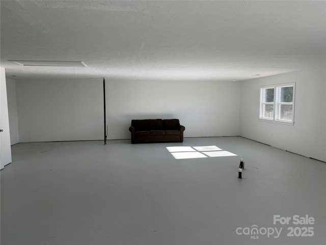 unfurnished room with a textured ceiling