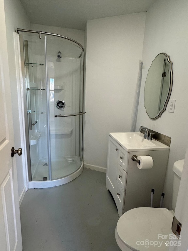 bathroom featuring concrete flooring, vanity, a shower with shower door, and toilet