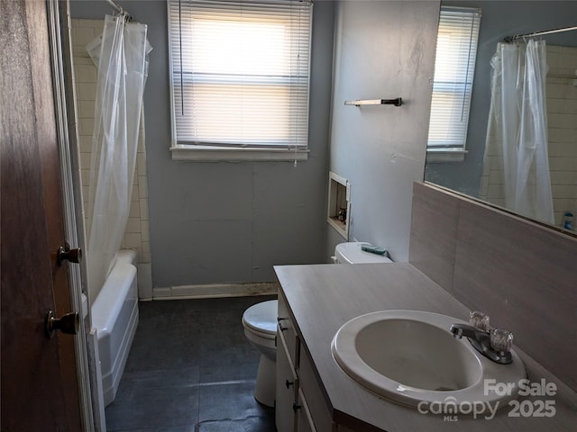 full bathroom with shower / bath combo, vanity, tile patterned floors, and toilet