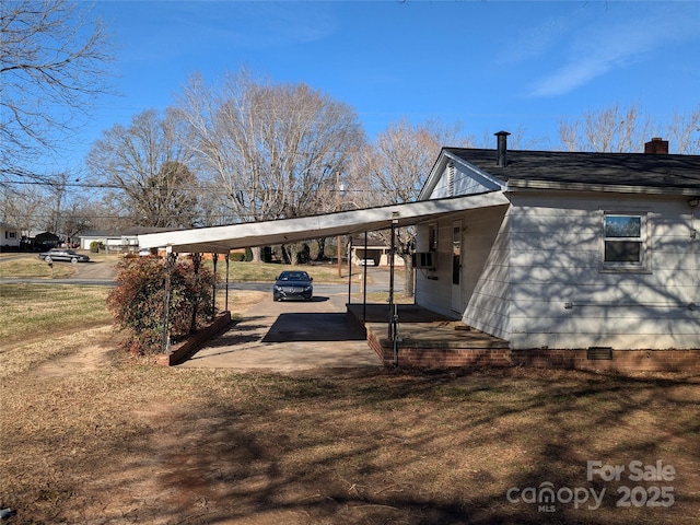 exterior space with a carport and a yard