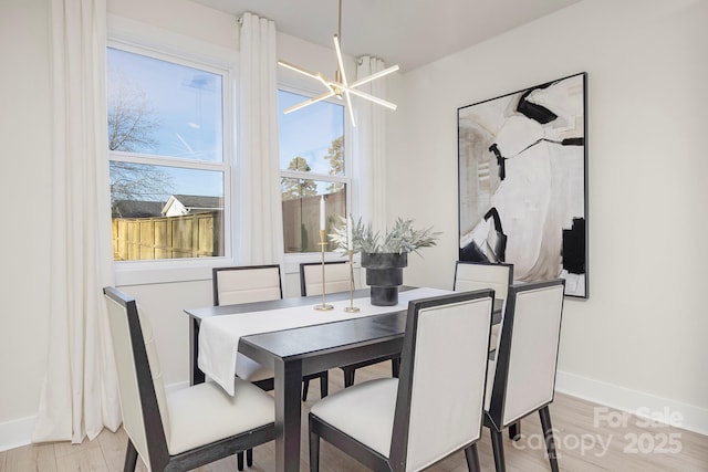 dining space featuring a chandelier and light wood-type flooring