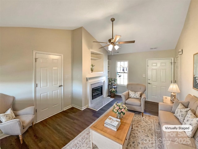 living room featuring dark wood-type flooring, vaulted ceiling, and ceiling fan