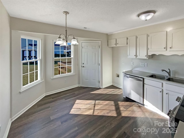 kitchen featuring sink, white cabinetry, decorative light fixtures, appliances with stainless steel finishes, and dark hardwood / wood-style flooring