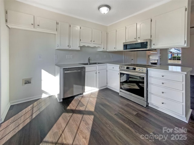 kitchen with white cabinetry, appliances with stainless steel finishes, kitchen peninsula, and dark wood-type flooring