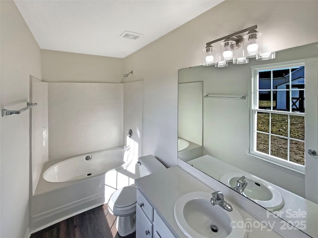 full bathroom with wood-type flooring, toilet, tub / shower combination, and vanity