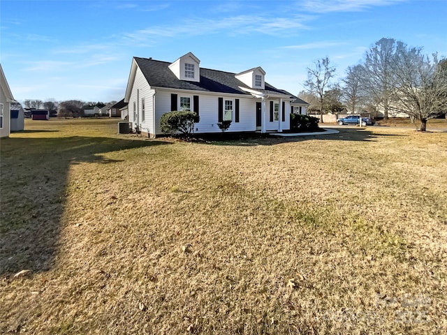 exterior space featuring a lawn and central air condition unit