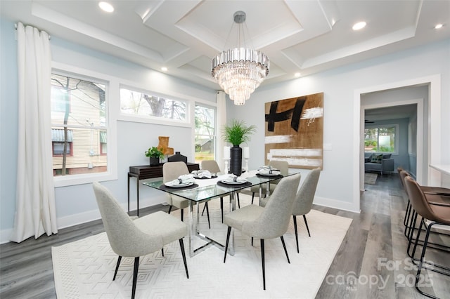 dining space with wood-type flooring and an inviting chandelier