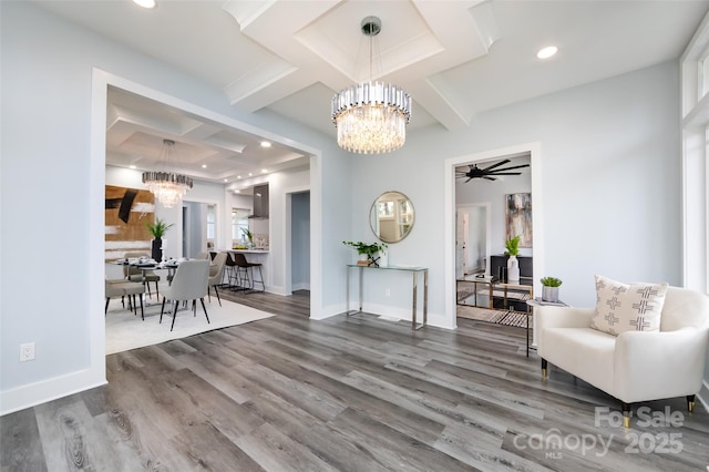 interior space featuring wood-type flooring, coffered ceiling, ceiling fan with notable chandelier, and beam ceiling