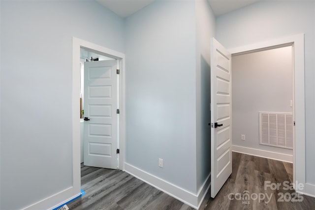 hallway featuring dark hardwood / wood-style flooring