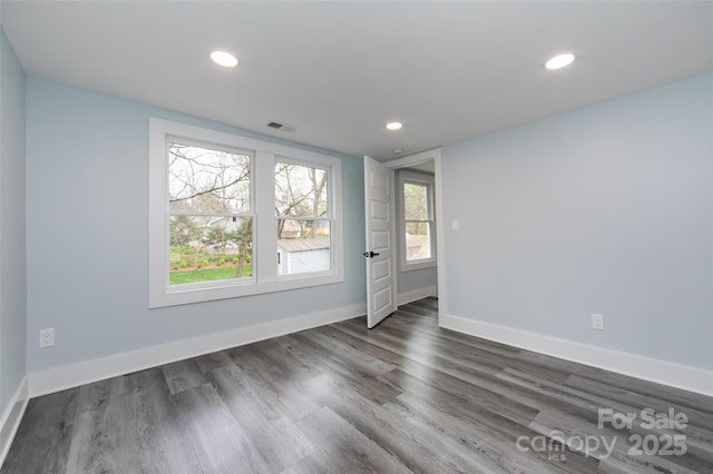 unfurnished room featuring dark hardwood / wood-style flooring