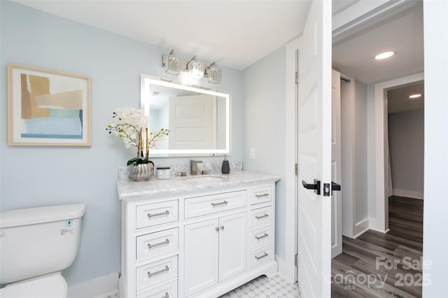 bathroom featuring vanity and toilet