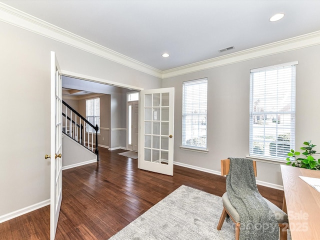 office area with dark wood-style floors, baseboards, visible vents, and ornamental molding