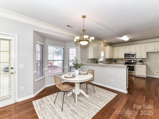 dining room with a notable chandelier, dark wood-style flooring, visible vents, and baseboards