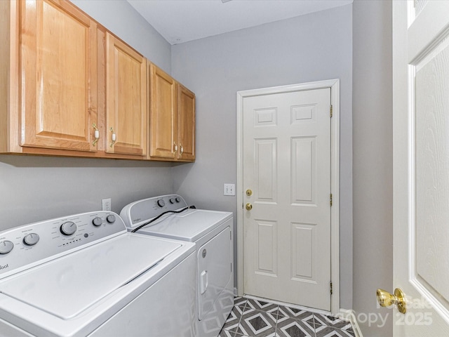 laundry area with cabinet space, dark floors, and washer and dryer