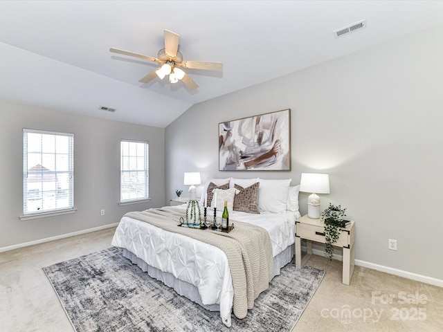 carpeted bedroom with ceiling fan, baseboards, visible vents, and vaulted ceiling