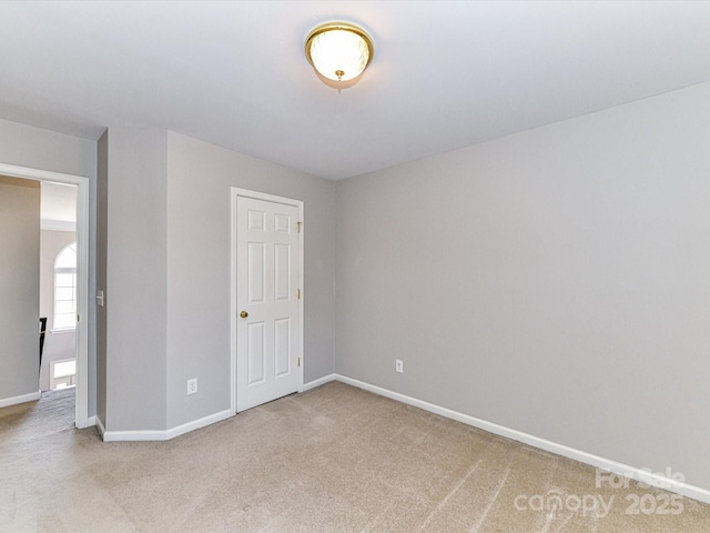 unfurnished bedroom with carpet flooring and baseboards