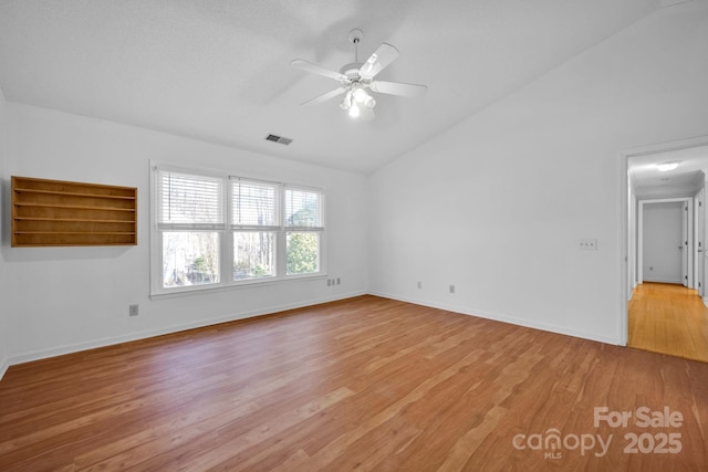 unfurnished room featuring ceiling fan, lofted ceiling, and light hardwood / wood-style floors