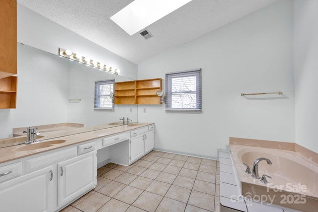 bathroom featuring a tub to relax in, vanity, lofted ceiling with skylight, and a wealth of natural light