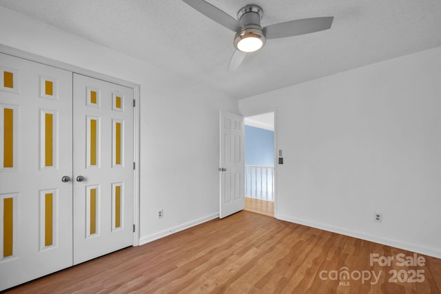 unfurnished bedroom with a closet, light hardwood / wood-style flooring, and a textured ceiling