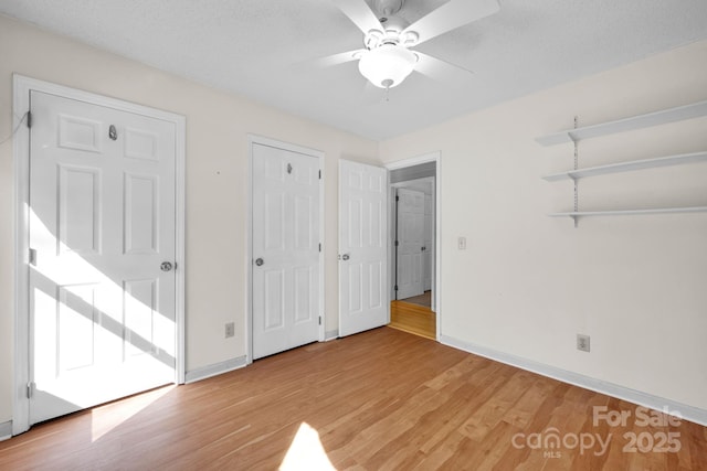 unfurnished bedroom featuring a textured ceiling, light hardwood / wood-style flooring, and ceiling fan