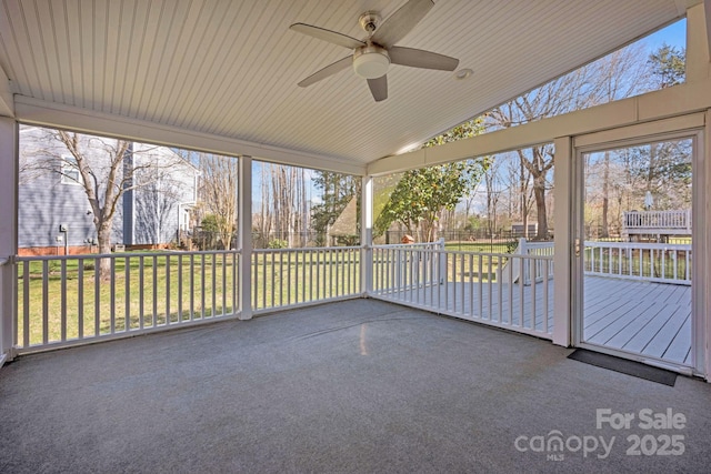 unfurnished sunroom with ceiling fan and vaulted ceiling