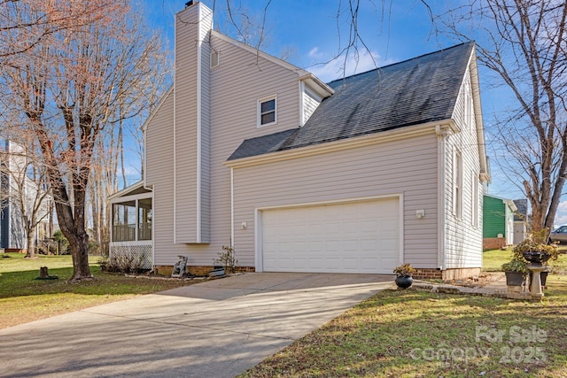 view of home's exterior featuring a garage, a yard, and a sunroom