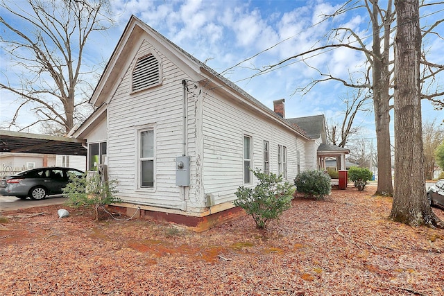 view of side of property with a carport