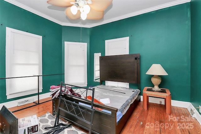 bedroom with crown molding and hardwood / wood-style floors