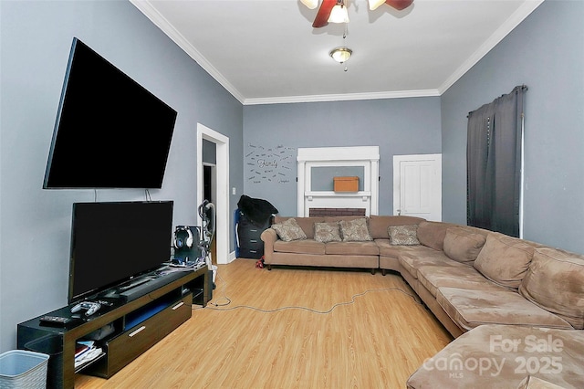 living room with ornamental molding, hardwood / wood-style floors, and ceiling fan