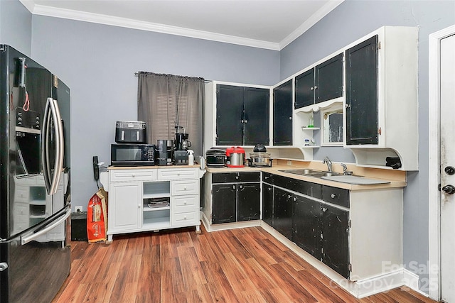 kitchen with crown molding, dark hardwood / wood-style floors, sink, and black appliances