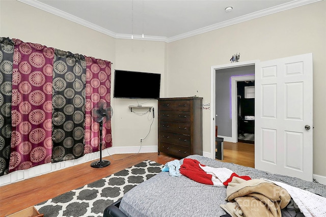 bedroom featuring crown molding and hardwood / wood-style floors