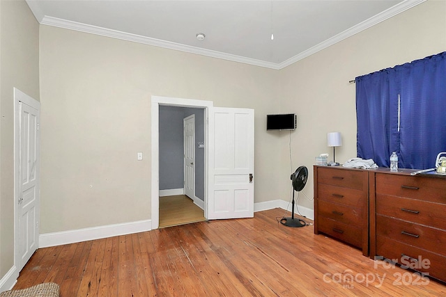 unfurnished bedroom featuring ornamental molding and light hardwood / wood-style flooring