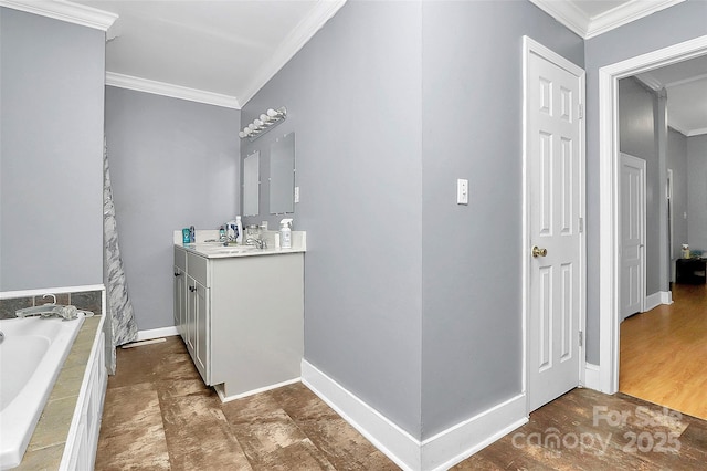 bathroom with crown molding, vanity, and tiled tub