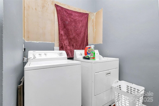 clothes washing area with washer and clothes dryer