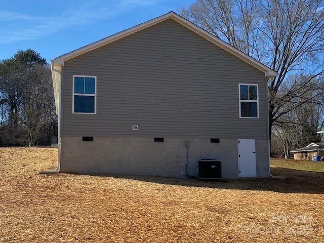 view of side of property with central AC