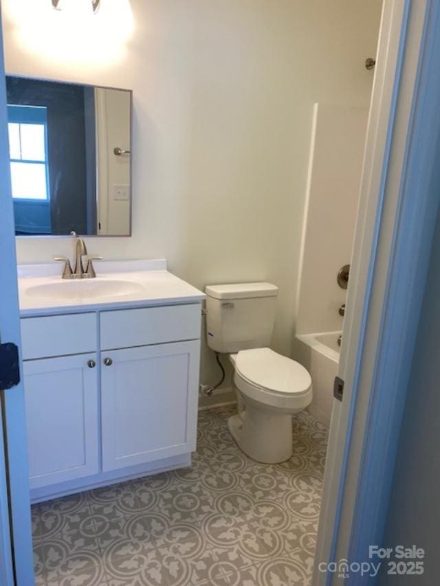 bathroom with tile patterned flooring, vanity, and toilet